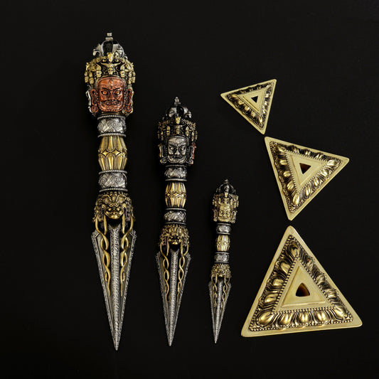 A 21cm Purba Vajra Dagger crafted from yellow copper, brass, and white copper, designed for Tibetan Buddhist rituals. Handcrafted with great care, this three-sided ritual tool is perfect for spiritual rituals, protection, and meditation.