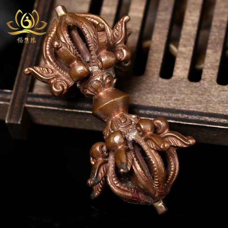 Handcrafted brass nine-pronged Vajra Phurba, inspired by Tibetan Buddhist ritual implements culture, showcasing traditional Buddhist ritual implements art.