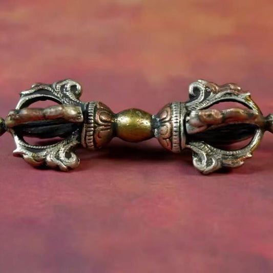 Handcrafted brass Khyemvra Vajra, featuring Nepalese five-pronged design with tricolor accents, inspired by Tibetan Buddhist ritual implements culture and Buddhist ritual implements art.