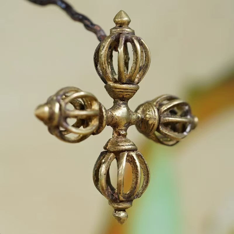 Pure brass cross Vajra with intricate design, handcrafted in Tibetan Buddhist ritual implements culture, an exquisite piece of Buddhist ritual implements art for altars.