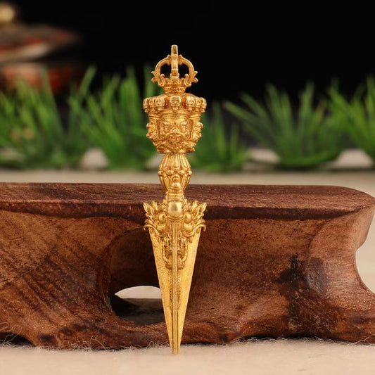 Vintage brass vajra phurba pendant inspired by Tibetan Buddhist ritual implements culture and sacred Buddhist ritual implements art