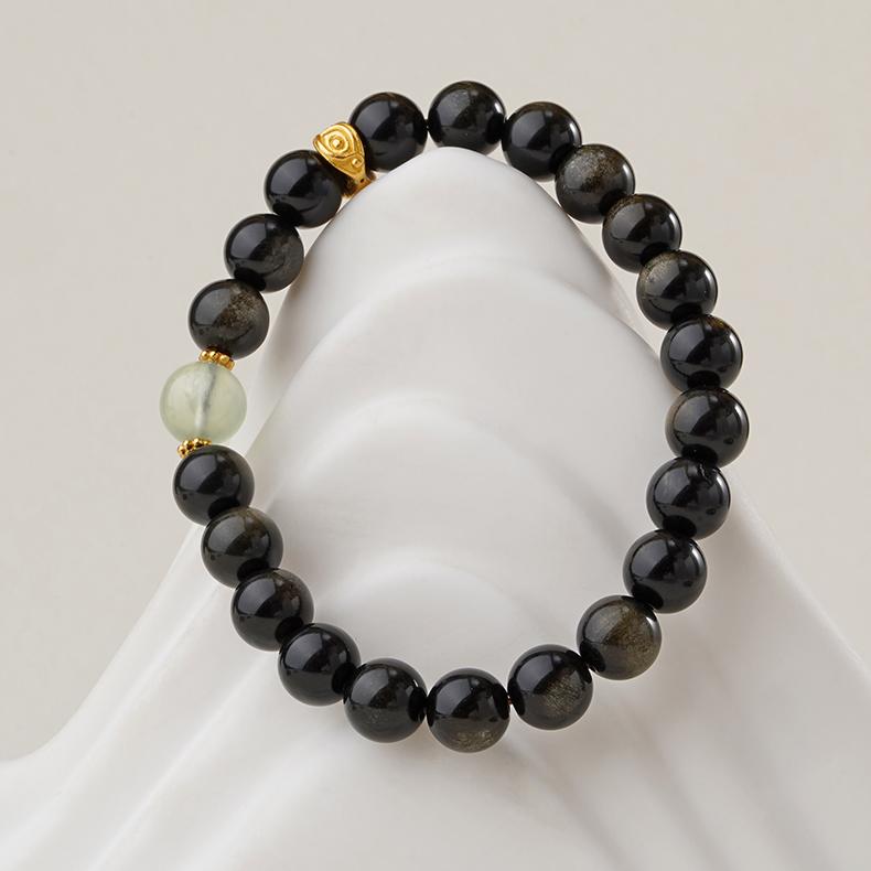 Experience inner peace with this artisan-crafted goldstone and peridot bracelet. Perfectly combining Tibetan jewelry art with healing energy for the soul.