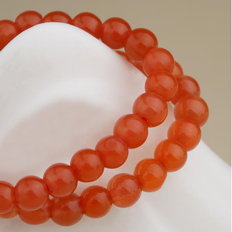 Explore the fusion of Tibetan artistry and symbolism with this red agate bracelet, handmade by artisans and designed to support personal growth and spiritual awakening.