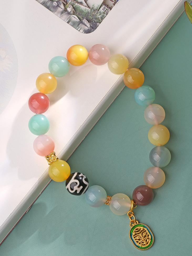 Artistic Purple Agate Dzi Bead Bracelet handcrafted in the tradition of Tibetan Buddhist jewelry culture. A symbol of spiritual enlightenment, perfect for meditation and personal growth.