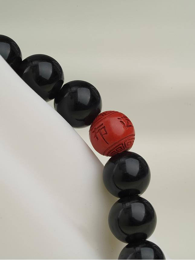 Healing black obsidian bracelet inspired by Tibetan Buddhist culture, handmade for spiritual protection and daily use. Jewelry art for strength.