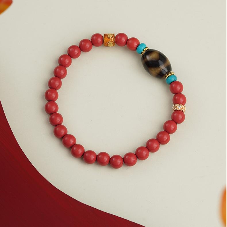Handmade Tibetan Buddhist cinnabar bracelet featuring hand-painted beads and traditional jewelry art craftsmanship for protection and blessings.