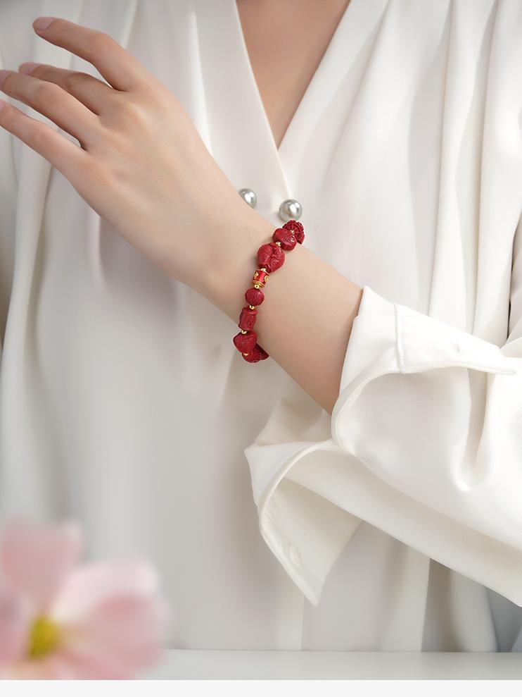 Tibetan Buddhist Jewelry Culture Cinnabar bracelet with copper details and a lotus flower symbol. Handmade with precision for protection and spiritual clarity.