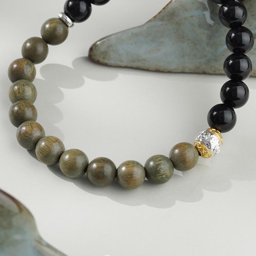 Pure handmade Tibetan Buddhist bracelet made from Obsidian and Green Sandalwood. This jewelry art piece is designed to bring protection, peace, and balance, making it perfect for anyone seeking to enhance their spiritual journey or practice