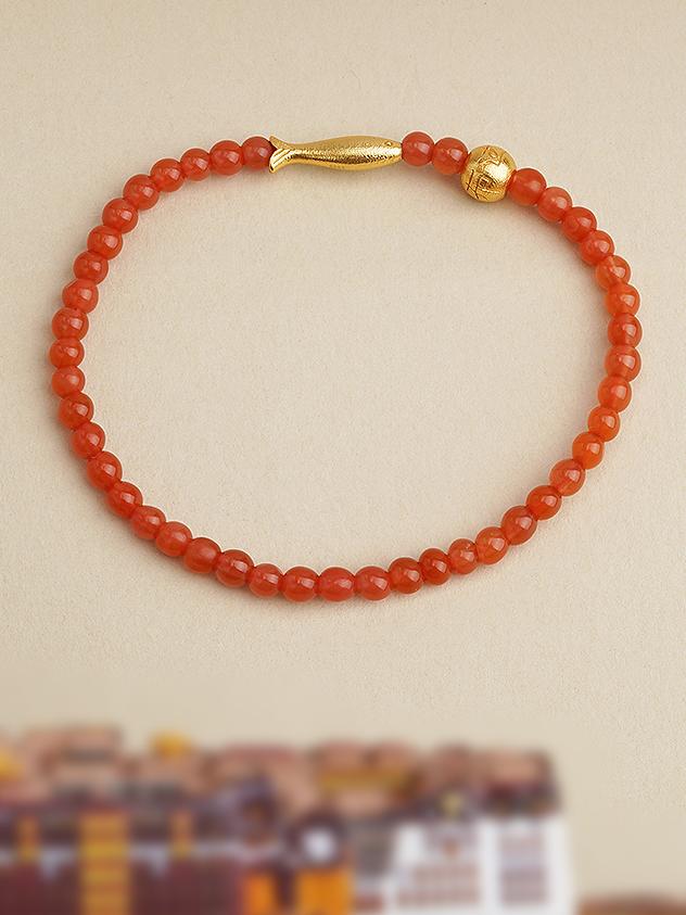 A beautifully handcrafted Southern red agate bracelet, designed to promote spiritual balance and well-being, enriched with Tibetan symbolism and craftsmanship.