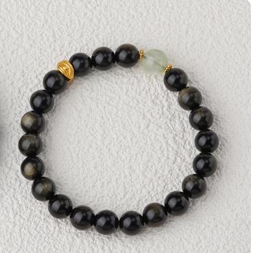 A handcrafted bracelet featuring goldstone and peridot, showcasing traditional Tibetan artistry. This unique design brings spiritual balance and protection.