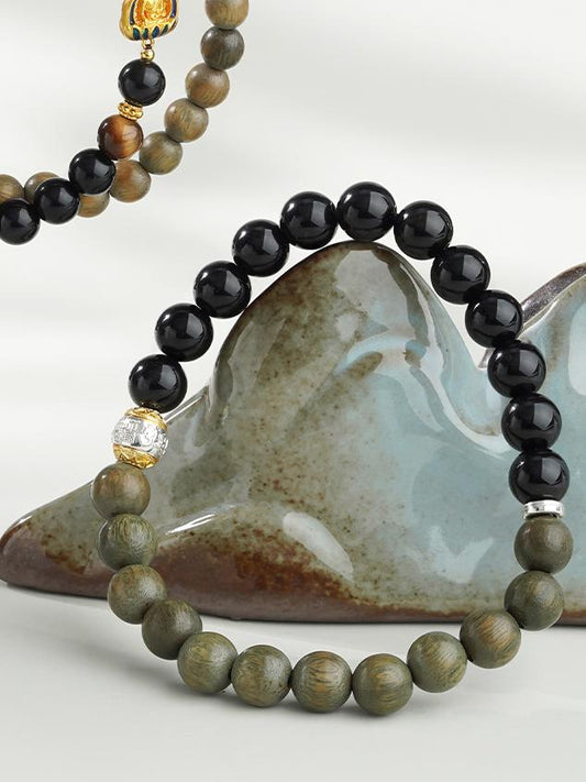 Pure handmade bracelet combining Obsidian and Green Sandalwood, crafted using traditional Tibetan Buddhist techniques. This jewelry piece symbolizes spiritual protection, balance, and inner peace, making it a meaningful accessory for mindful living