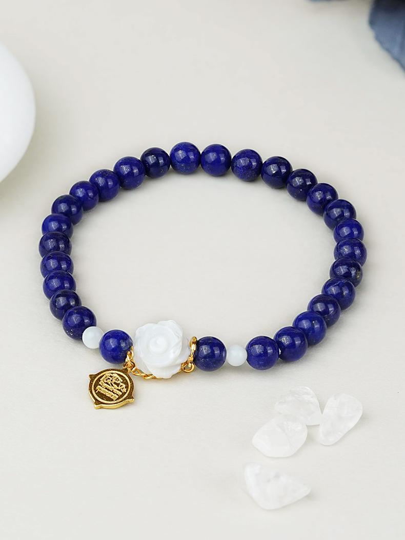 Handmade lapis lazuli and carved shell bracelet inspired by Tibetan Buddhist Jewelry Culture, featuring artisan jewelry art details.