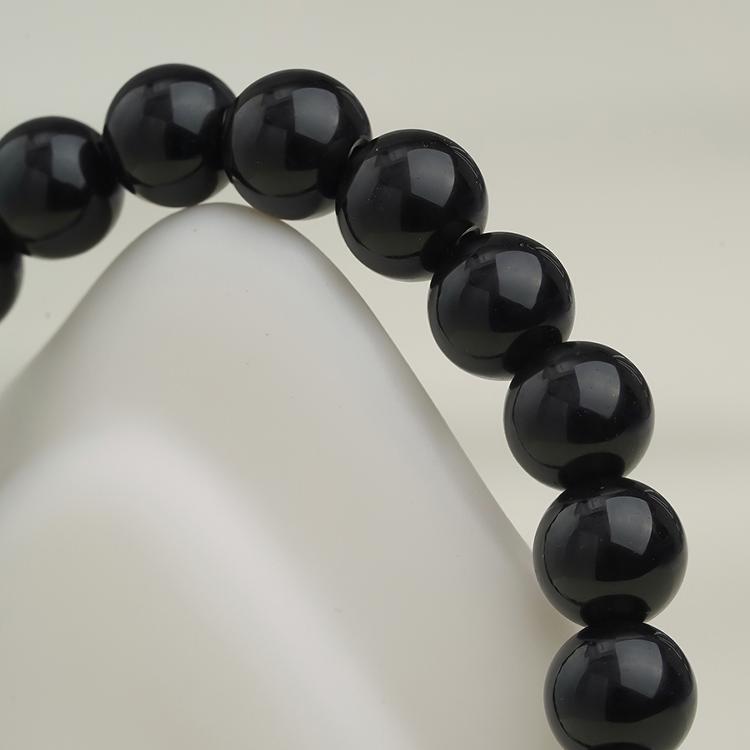 Tibetan Buddhist black obsidian bracelet for meditation and energy healing. Handcrafted jewelry art promoting calm and inner peace.
