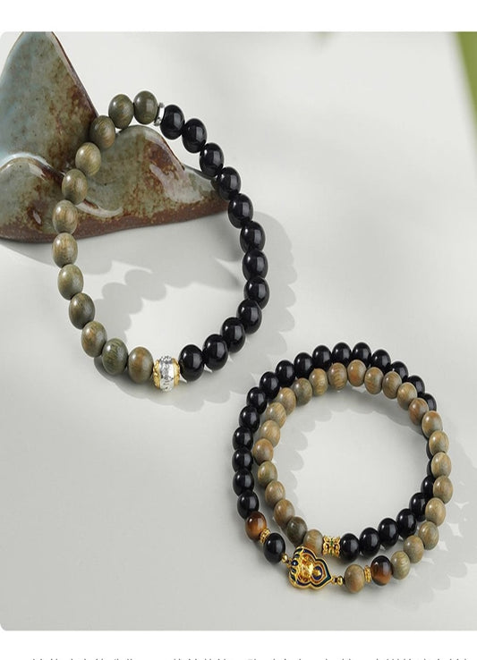 Pure handmade Tibetan Buddhist bracelet featuring Obsidian and Green Sandalwood beads. This artisan piece symbolizes spiritual protection and inner peace, designed for those who appreciate fine jewelry with deep cultural meaning
