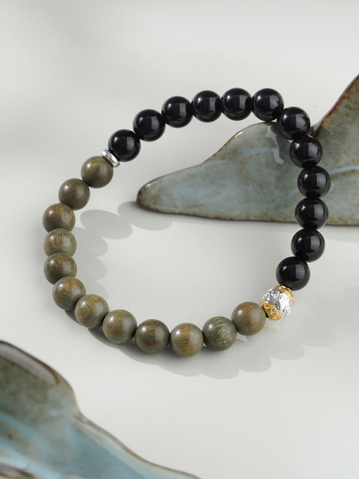 Handmade Tibetan Buddhist bracelet featuring Green Sandalwood and Obsidian beads. Crafted with care and spiritual intent, this bracelet enhances mindfulness, provides emotional balance, and offers powerful protection against negative energy.