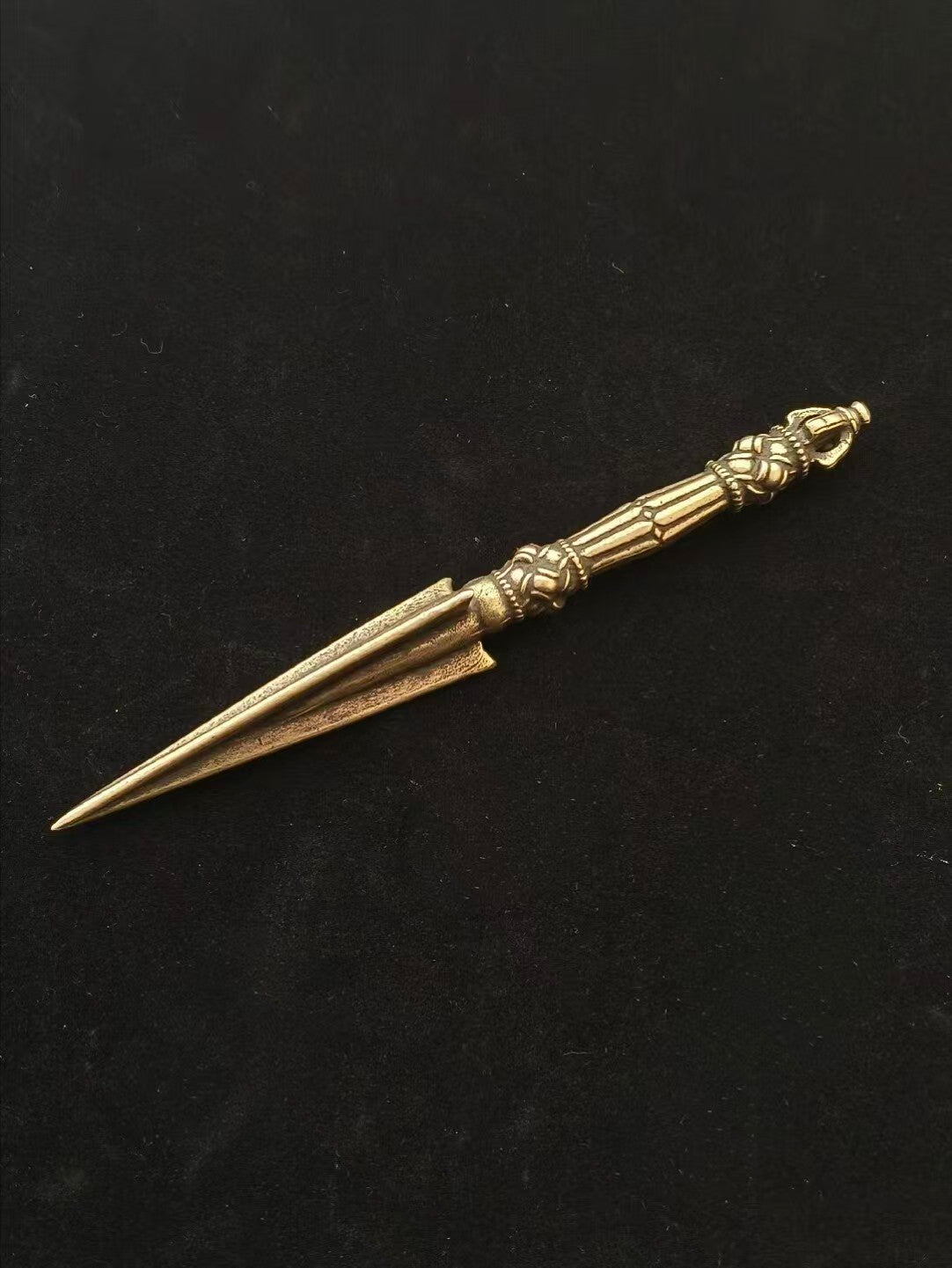 A beautifully crafted handcrafted brass Vajra Purba, this ritual implement showcases the exquisite artistry of Tibetan Buddhist ritual implements. Perfect for enhancing spiritual practice and for use in Tibetan Buddhist worship or as a sacred home décor piece.