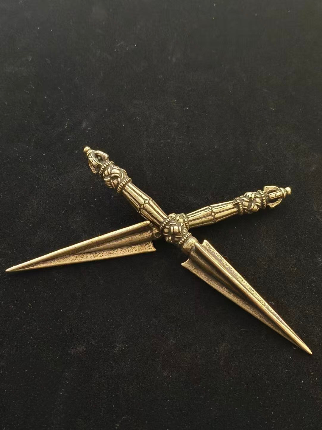 This intricately carved Tibetan Purba Vajra, made from solid brass, is designed for purification purposes. A vital piece of Tibetan Buddhist ritual implements culture, it is perfect for dispelling negative energies and is an essential addition to any sacred space or collection.