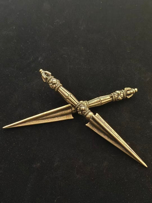 This intricately carved Tibetan Purba Vajra, made from solid brass, is designed for purification purposes. A vital piece of Tibetan Buddhist ritual implements culture, it is perfect for dispelling negative energies and is an essential addition to any sacred space or collection.