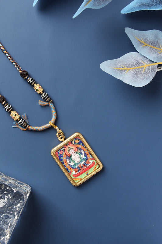 Luxury packaging and certificate of authenticity for the hand-painted Rebgong Avalokiteshvara Thangka pendant.