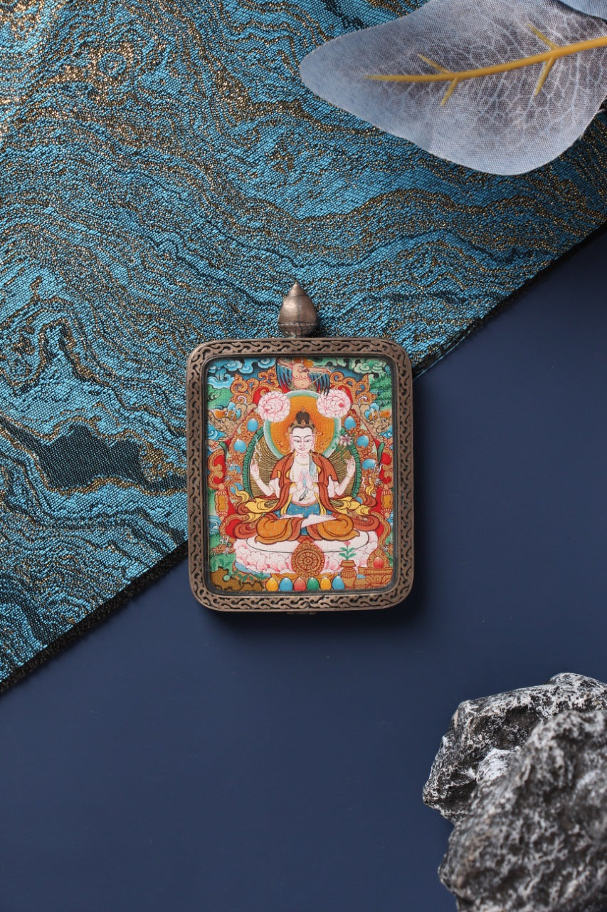 A 4x5cm hand-painted Four-Armed Avalokiteshvara (Chenrezig) Thangka in Menri style, encased in a silver Nine-Colored Deer frame.
