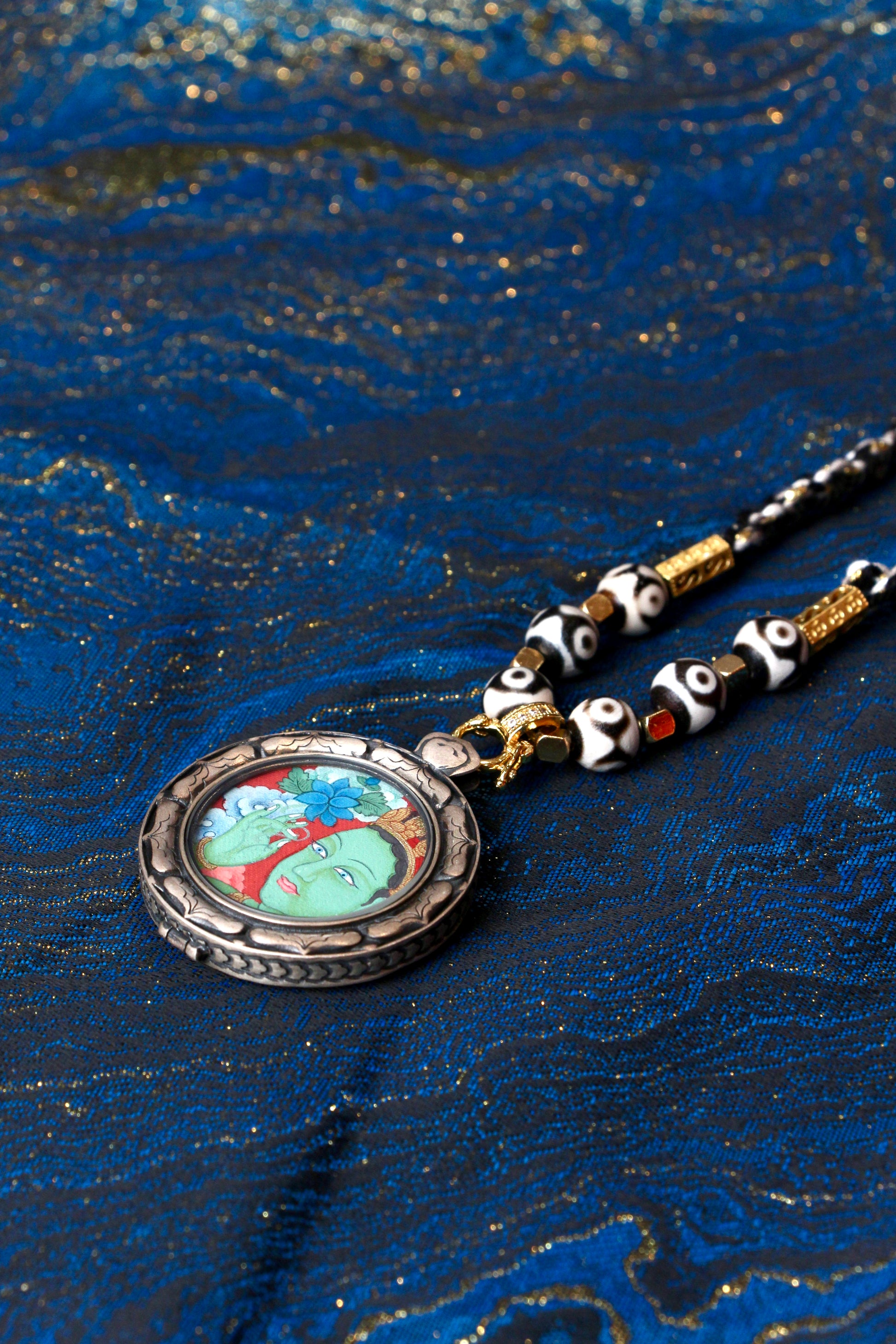 A portable Green Tara Thangka amulet designed for career success, relationship harmony, and spiritual protection.