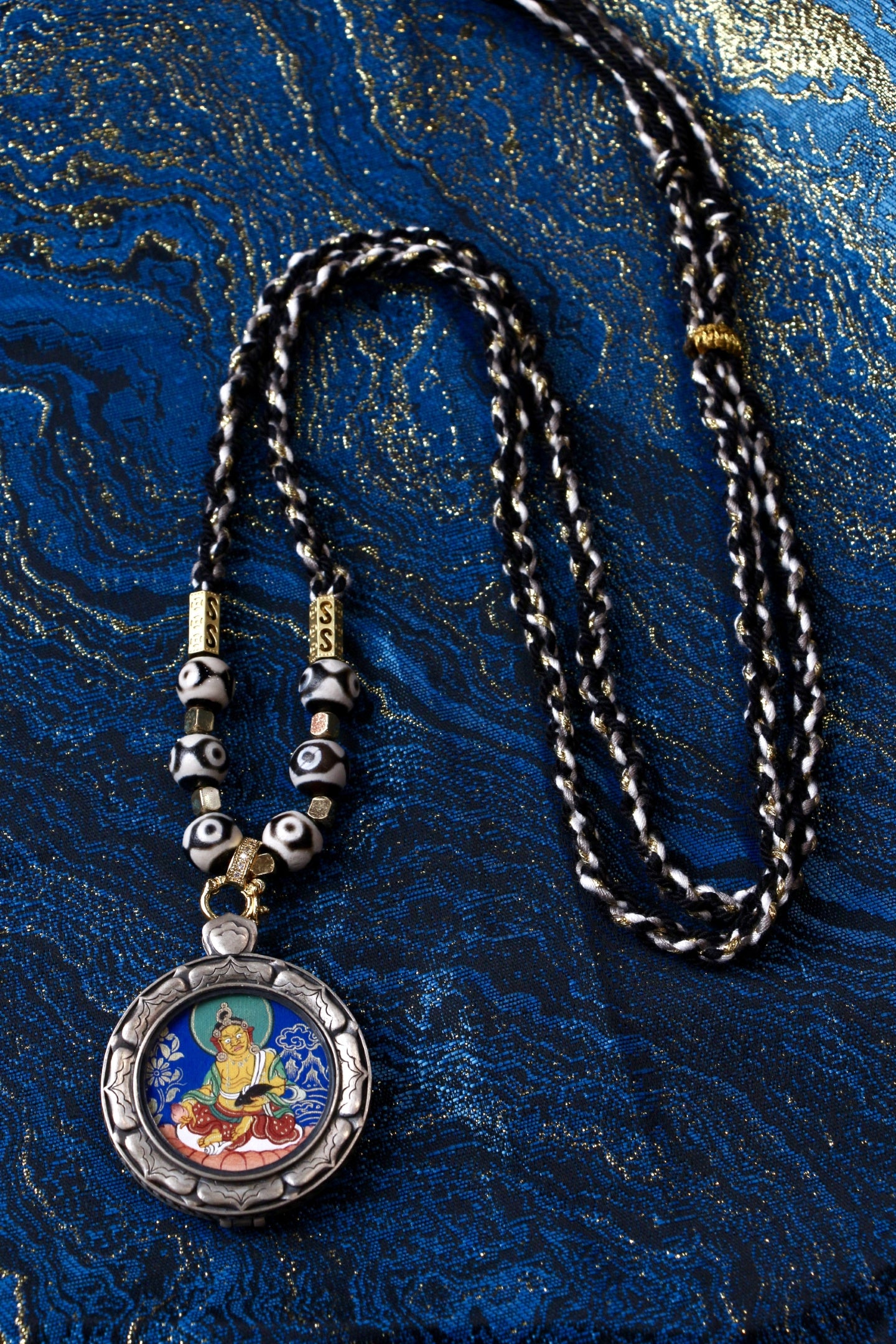 A sacred hand-painted Kurukulla (Red Tara) Buddha Head Thangka pendant from Tibet in an exclusive silver Three Rabbits case.