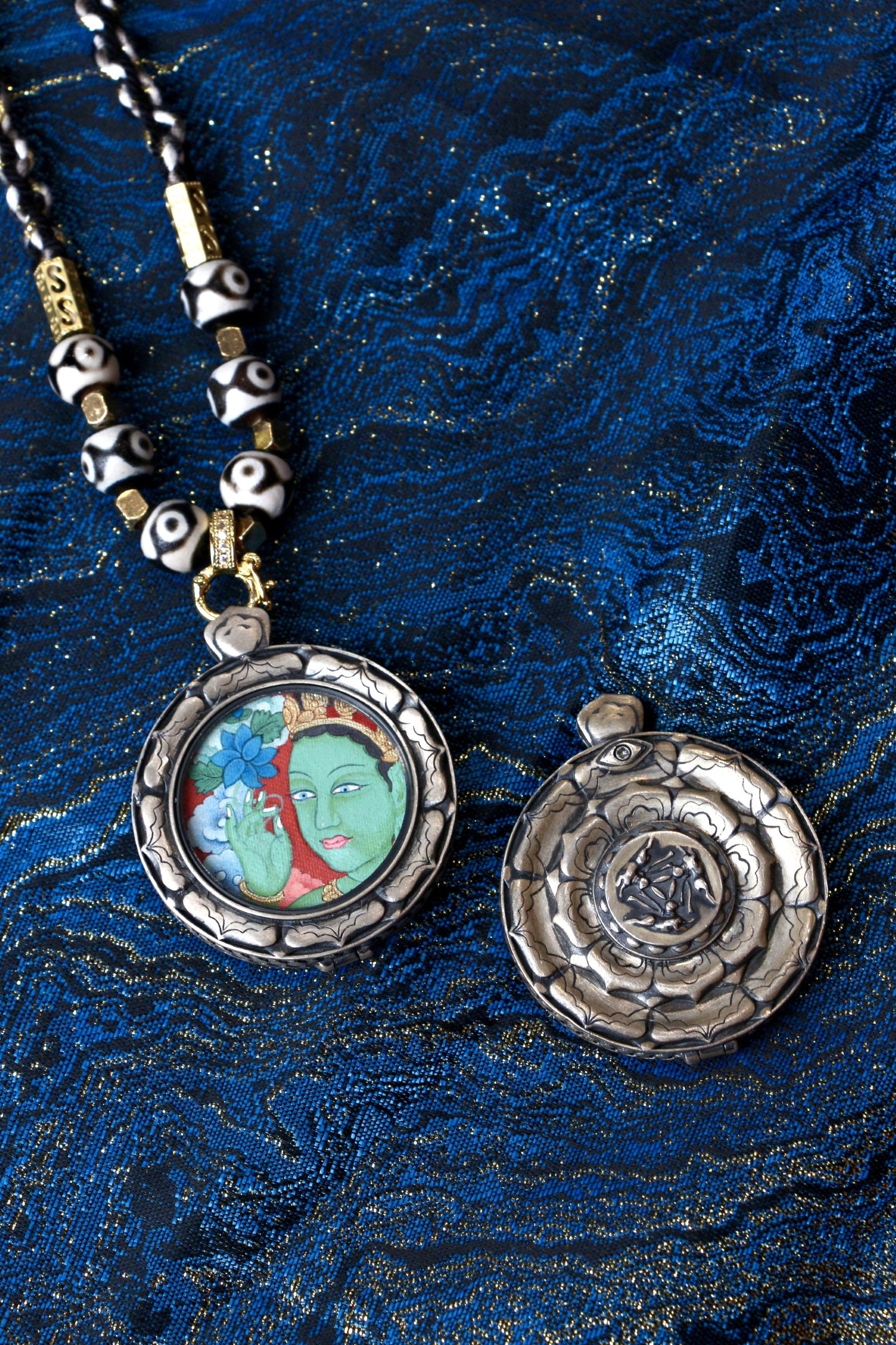 Detailed view of the patented S925 silver casing with the Three Rabbits Sharing Ears motif, a signature of this collectible thangka.