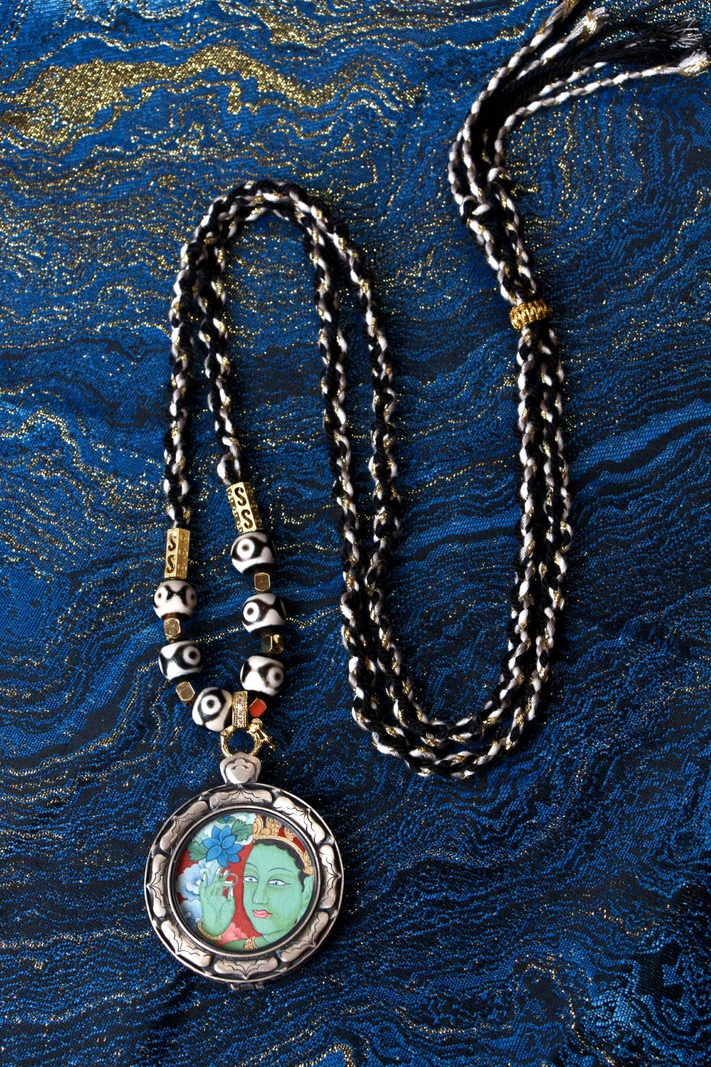 Close-up of the 2.5cm Green Tara Thangka core, showcasing the traditional vintage style and natural mineral pigments used by Tibetan masters.