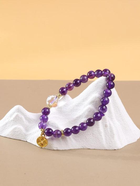 Handmade amethyst bead bracelet inspired by Tibetan Buddhist Jewelry Culture, featuring intricate craftsmanship and spiritual significance for balance and healing.