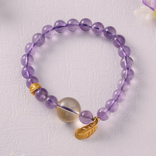 Elegant amethyst feather bracelet, combining Tibetan Buddhist symbolism with spiritual artistry, designed for peace, protection, and mindfulness.