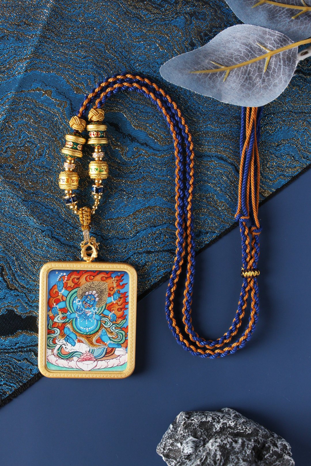 A 4x5cm hand-painted Six-Armed Mahakala Thangka pendant from Rebgong, featuring a blue cloud background and vintage copper frame.