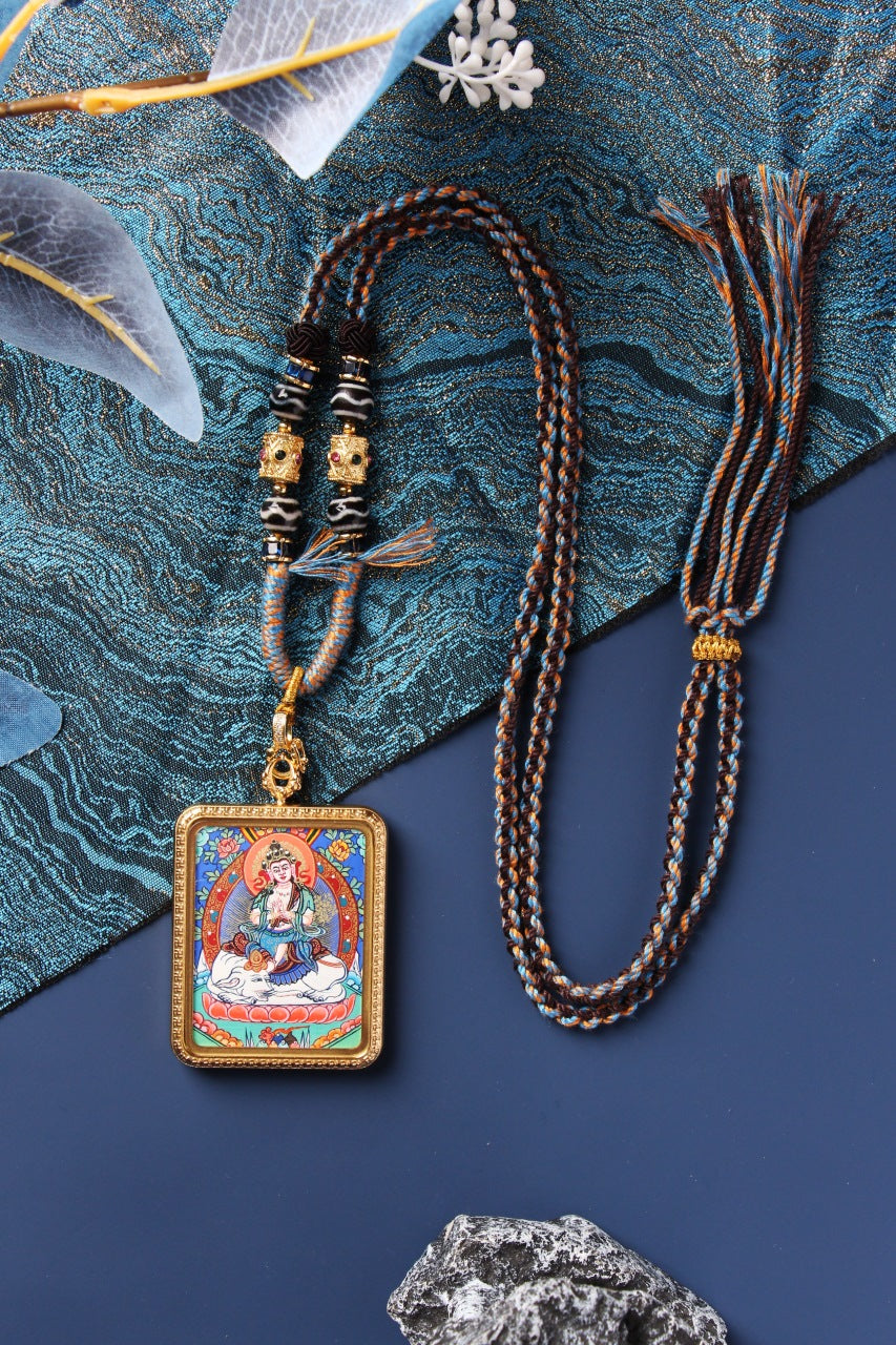 A Four-Armed Avalokiteshvara Thangka pendant from the Rebgong collection, representing compassion and zodiac protection.

