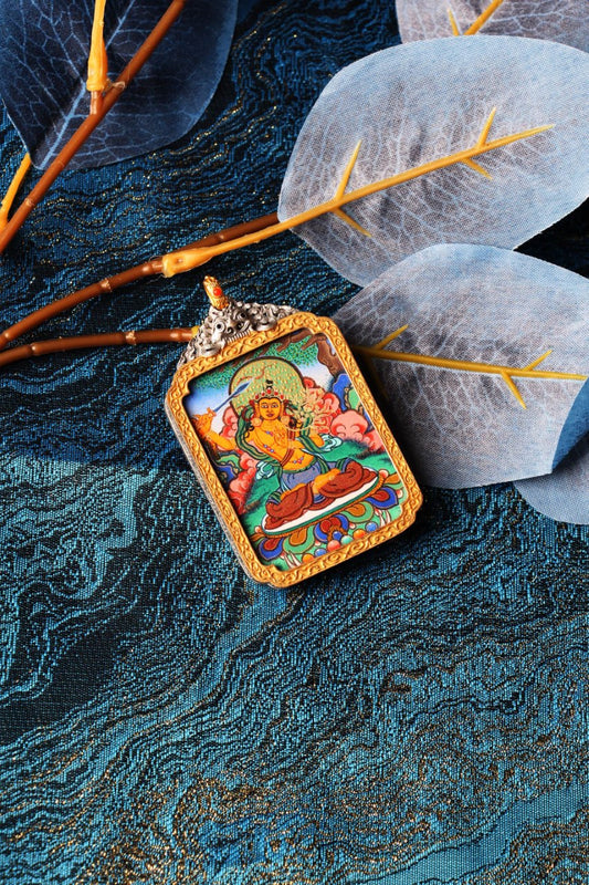 The complete Manjushri Thangka pendant as a sacred heirloom, showcasing the brilliant Rebgong artistry and premium electroplated silver casing.