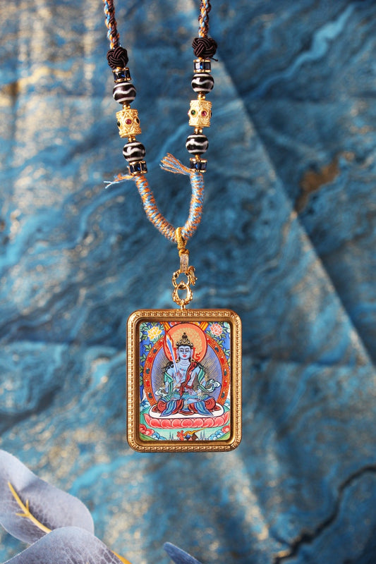 A 3.5x4.5cm hand-painted Rebgong Akasagarbha Thangka pendant, the Buddha of wealth, featuring vibrant mineral pigments and a gold-toned frame.
