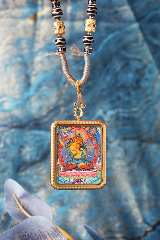  A Four-Armed Avalokiteshvara Thangka pendant from the Rebgong collection, paired with a traditional Tibetan beaded cord.

