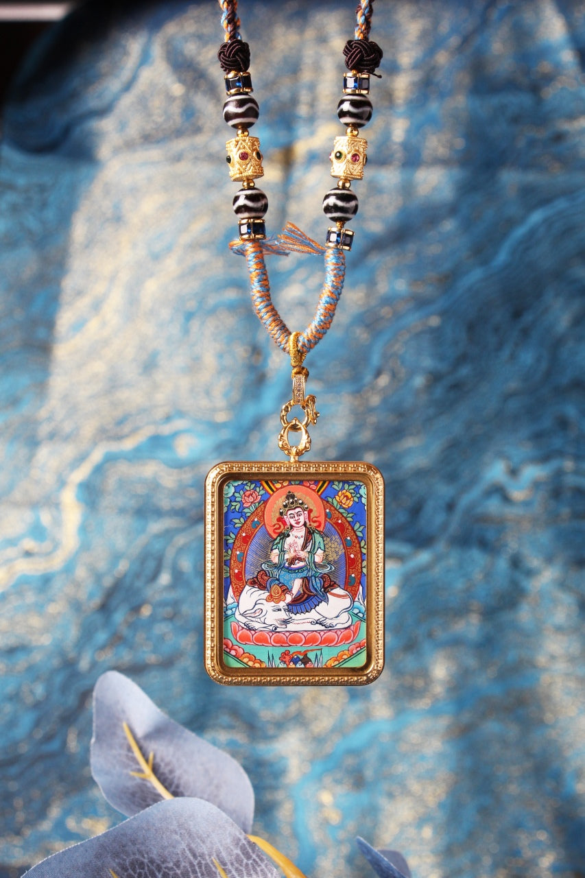 A 3.5x4.5cm Rebgong Samantabhadra Thangka pendant featuring the Bodhisattva on a white elephant, hand-painted with mineral pigments.
