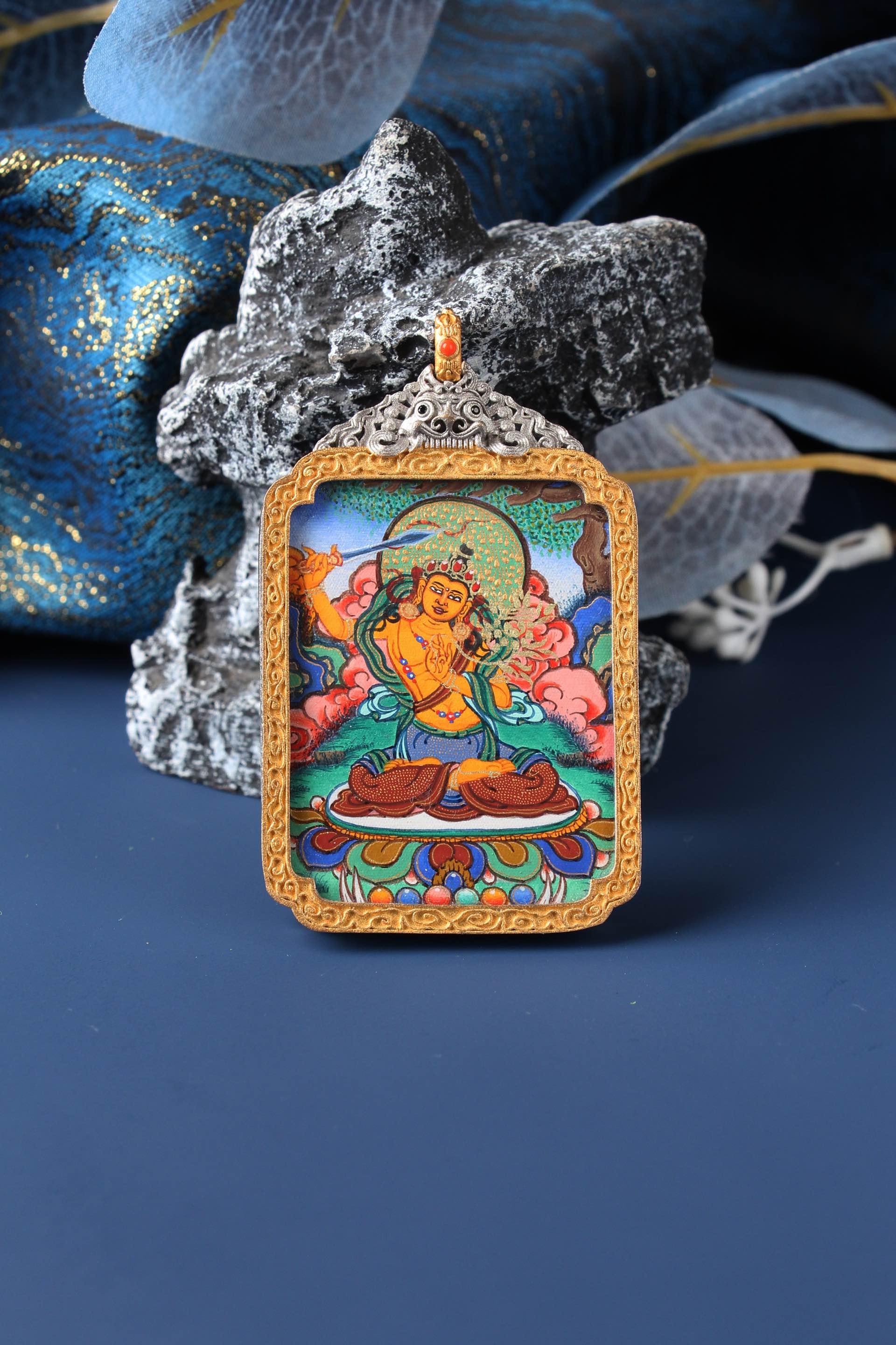 A 3.5x4.5cm high-end hand-painted Manjushri (Wen Shu) Thangka from Rebgong, the guardian for Zodiac Rabbit, in a silver protective frame.