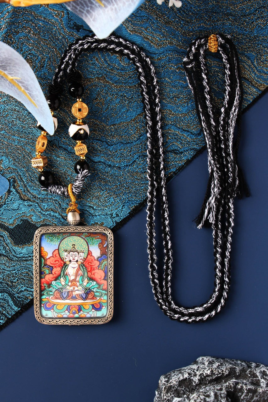 A 3.5x4.5cm high-end hand-painted Vairocana Buddha Thangka from Rebgong, the guardian for Zodiac Sheep and Monkey, in a silver Nine-Colored Deer frame.
