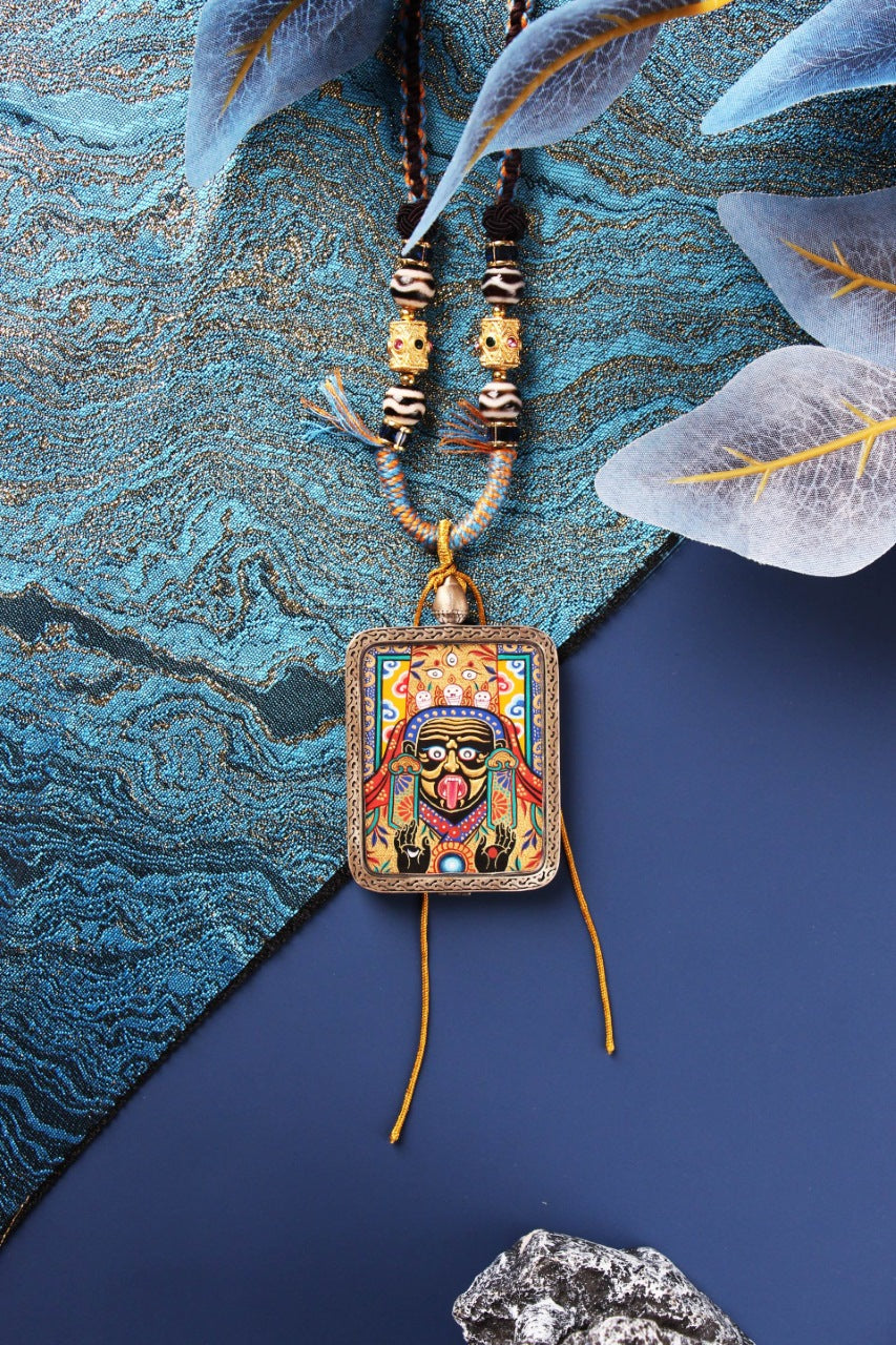A 3.5x4.5cm high-end hand-painted Zaki Lhamo Thangka from Rebgong with 3D raised gold powder technique and 925 silver frame.