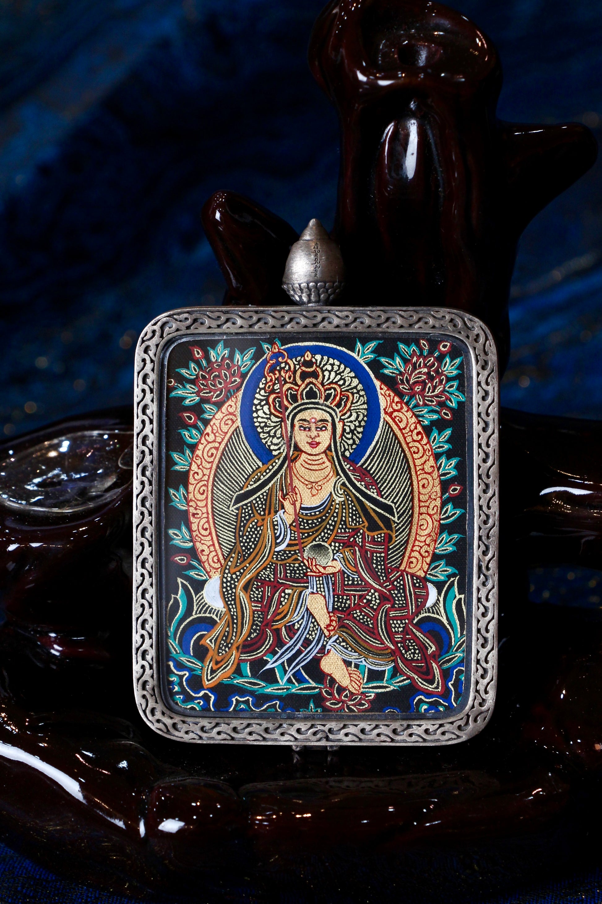 A sacred hand-painted Black Gold Kshitigarbha Bodhisattva Thangka pendant from Regong, featuring pure gold lines in a silver Nine-Colored Deer frame.