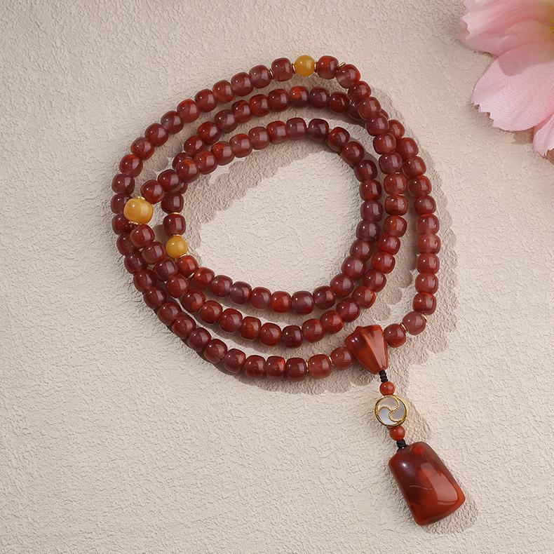 Handmade Tibetan Buddhist 925 silver necklace with South Red Agate, amber, and 108 prayer beads symbolizing wisdom and prosperity.