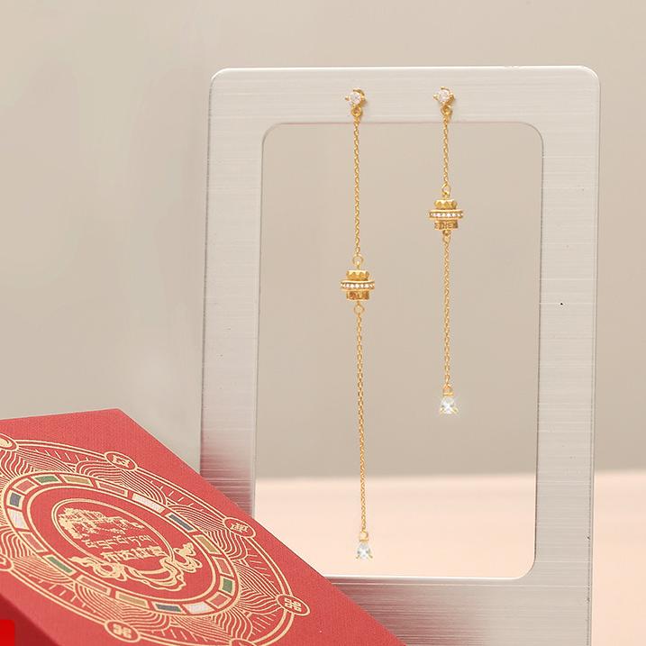 "Artisan-crafted 925 silver earrings with 18K gold and zircon, inspired by Tibetan Buddhist symbols of prosperity and good fortune."