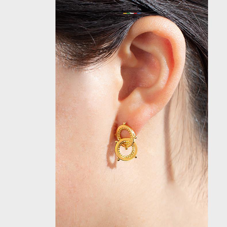 "Artisan-crafted 925 silver earrings with gold plating, inspired by Tibetan Buddhist themes of connection and mutual support."