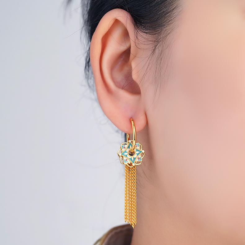 "Tibetan Buddhist Lian Kai Fan Hua earrings with 925 silver, hollow lotus flower design, and silver tassels, symbolizing spiritual awakening."