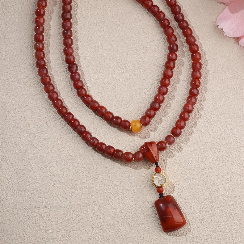 Artisan Tibetan silver and amber necklace with 108 red agate beads for meditation and mindfulness.