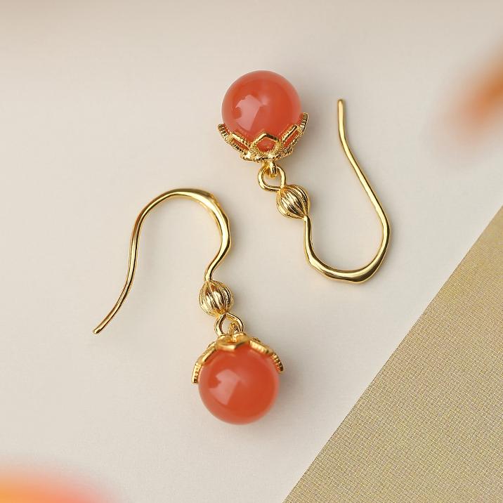 "Handmade Tibetan Buddhist Xiaoqingjing South Red Coral ear pendants in 925 silver, symbolizing purity and spiritual balance."