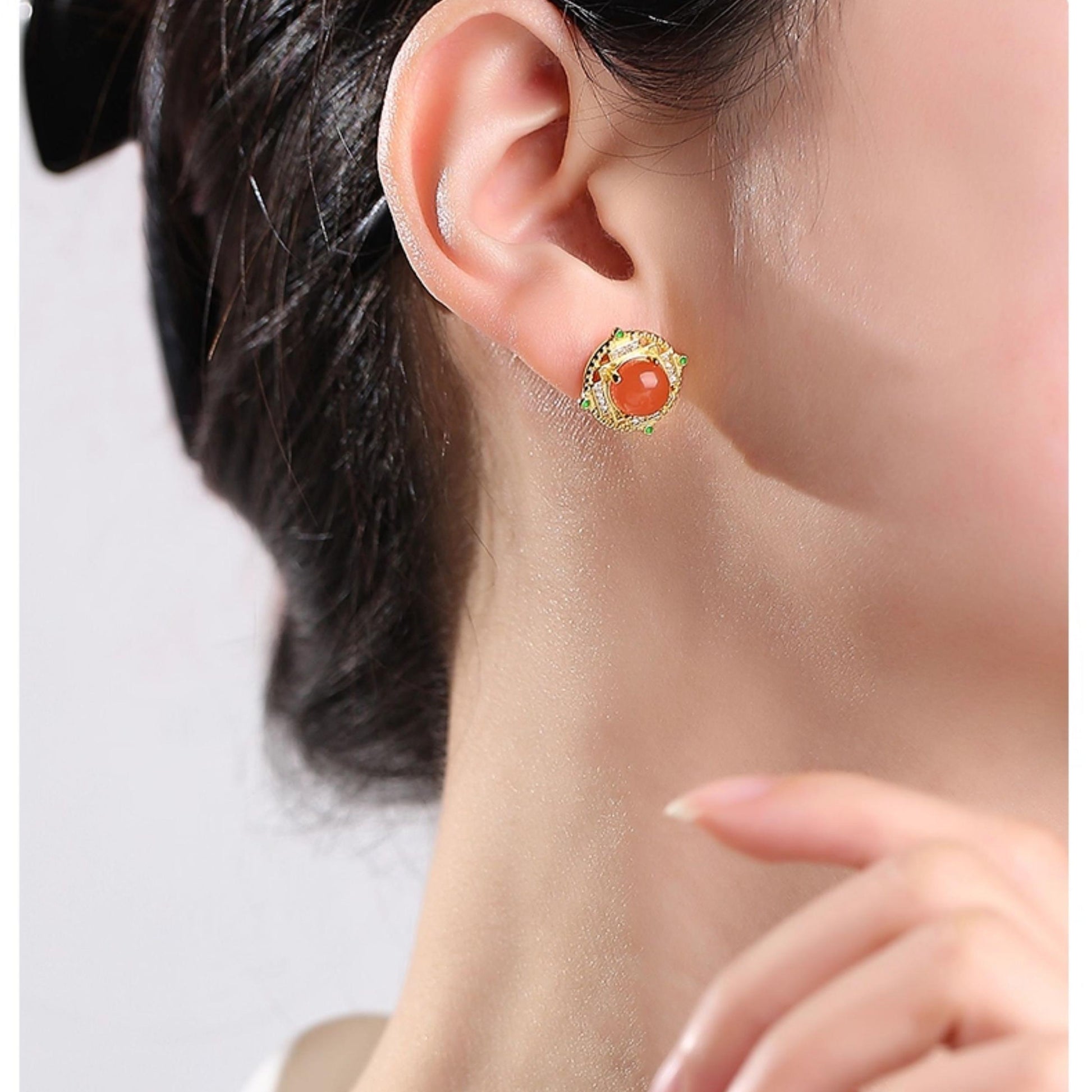 "Tibetan Buddhist-inspired ear studs with South Red Coral and 925 silver, representing spiritual joy, prosperity, and long-lasting happiness."