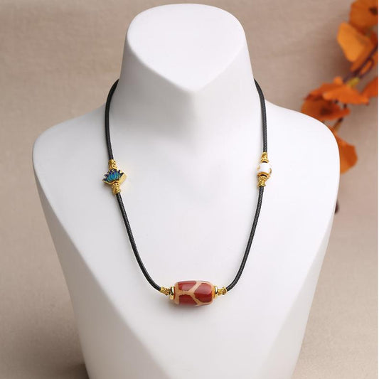 Tibetan Qihongrou Tianzu copper lotus pendant, handcrafted with red agate and copper alloy details.