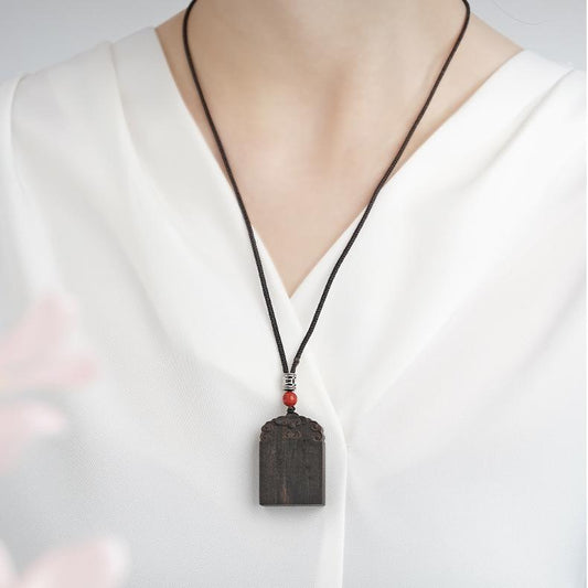 Handcrafted Tibetan Buddhist Kyara agarwood peace pendant symbolizing calm and protection.