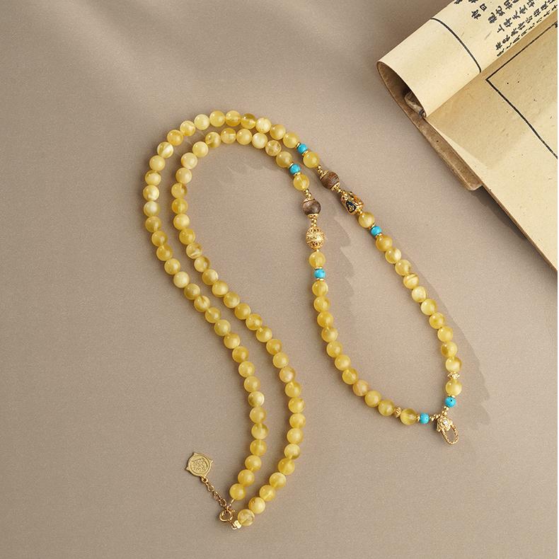 Artisan-crafted Tibetan Buddhist amber and agarwood pendant necklace for meditation and spiritual energy.